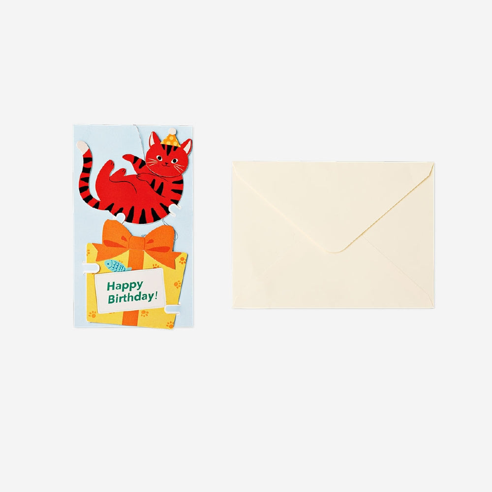 Office birthday card featuring a cat illustration holding a present, by Flying Tiger Copenhagen.