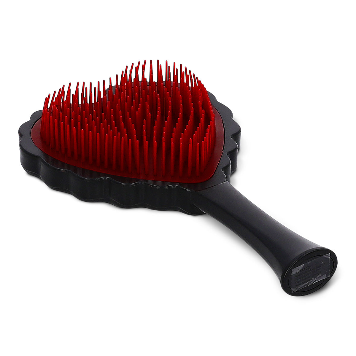 Red and black heart-shaped hairbrush for personal care by Flying Tiger Copenhagen, with a colorful, playful design.