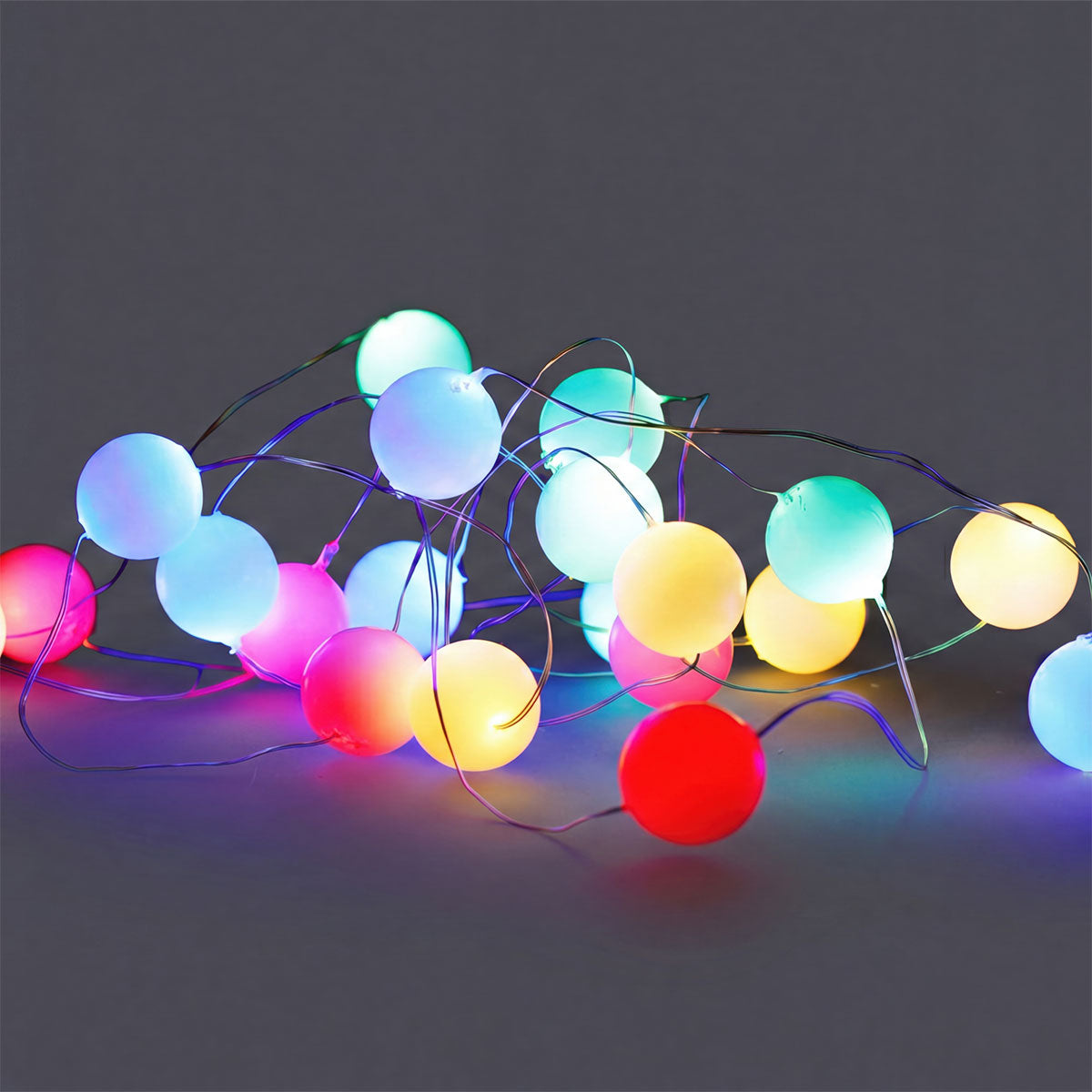 Multi-colored string lights for home from Flying Tiger Copenhagen, featuring vibrant bulbs for decorative indoor or outdoor use.