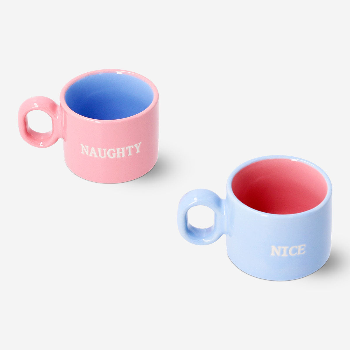 Two pastel ceramic cortado mugs with Christmas text from Flying Tiger Copenhagen, ideal for festive coffee occasions.