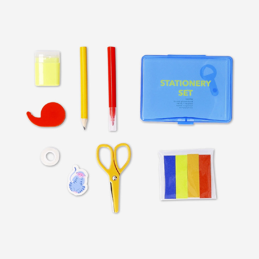 Office stationery set from Flying Tiger Copenhagen in a box, including pens, pencils, scissors, and notepads for organized workspace.