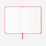 Pink A5 office notebook with pom poms from Flying Tiger Copenhagen, featuring a soft cover and decorative pom pom accents.