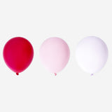 Assorted metallic rose-colored balloons for party decoration, featuring a mix of shiny, reflective balloons from Flying Tiger Copenhagen.