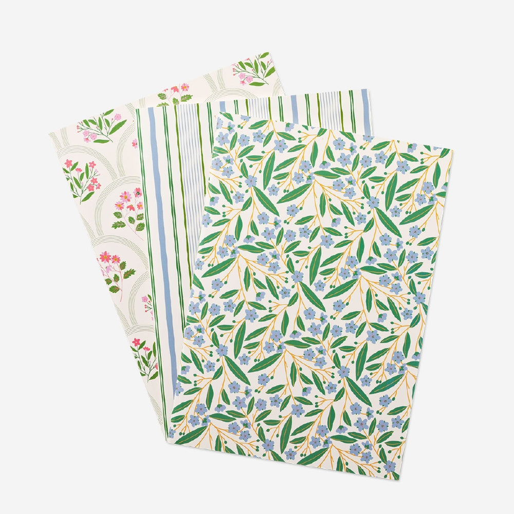 Three Flying Tiger Copenhagen A5 floral notebooks for office use, featuring colorful floral covers and lined pages.