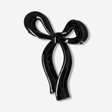 Black textile bow hairclip with a sleek design, perfect for styling hair and adding a touch of elegance.