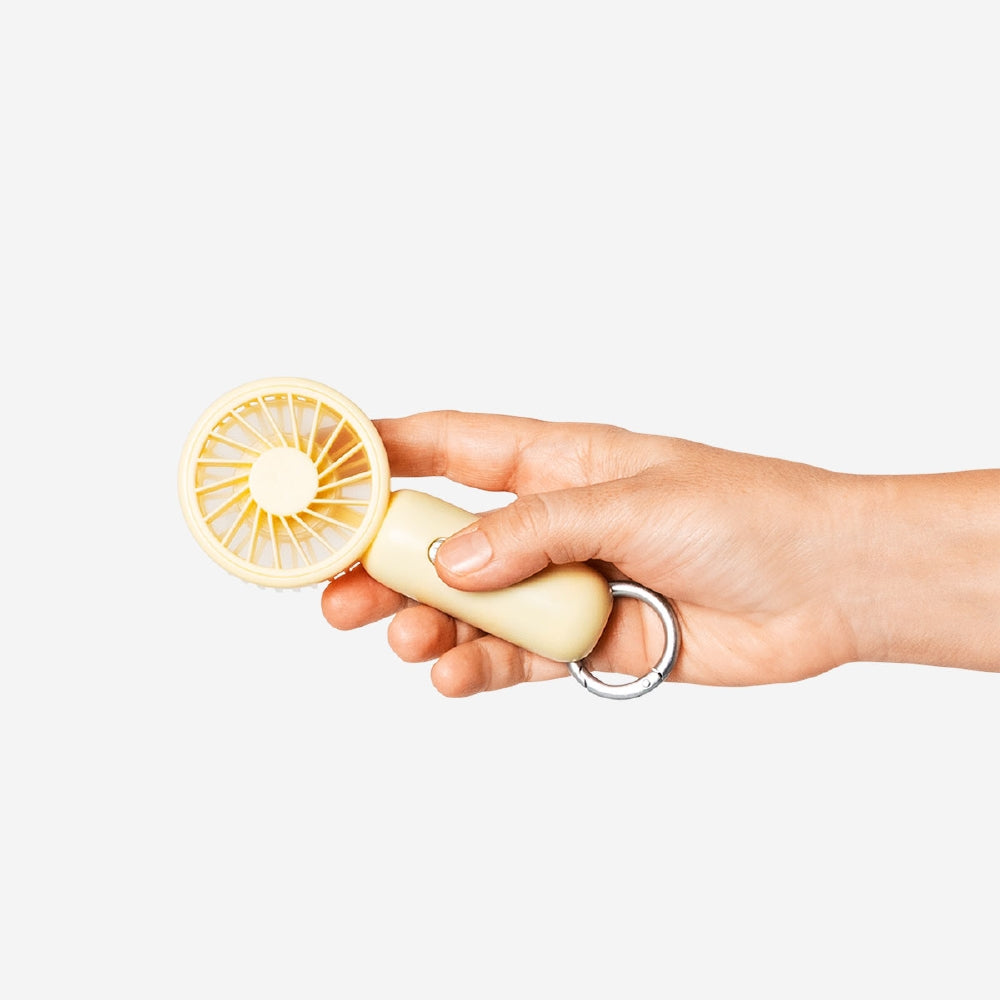 Yellow handheld fan with 3 adjustable settings from Flying Tiger Copenhagen, compact gadget for personal cooling.