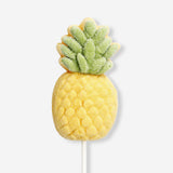 Pineapple-flavored marshmallow on a stick by Flying Tiger Copenhagen, showing a sweet, colorful treat on a wooden stick.