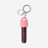 Refillable travel perfume bottle with silicone cover and carabiner, designed for convenient on-the-go fragrance use by Flying Tiger Copenhagen