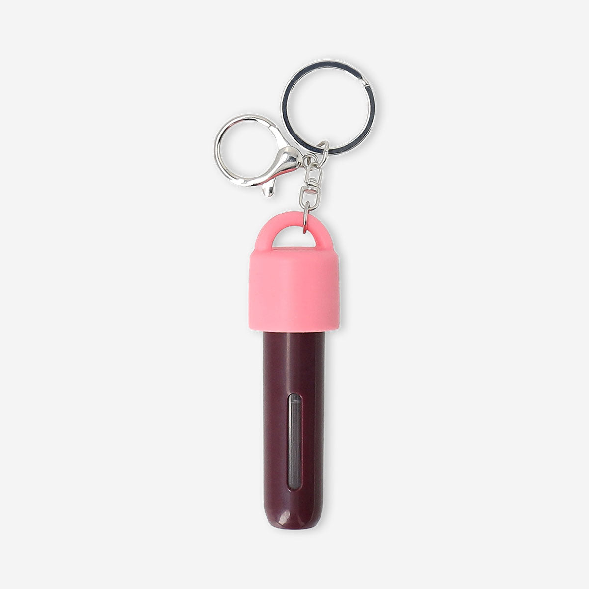 Refillable travel perfume bottle with silicone cover and carabiner, designed for convenient on-the-go fragrance use by Flying Tiger Copenhagen