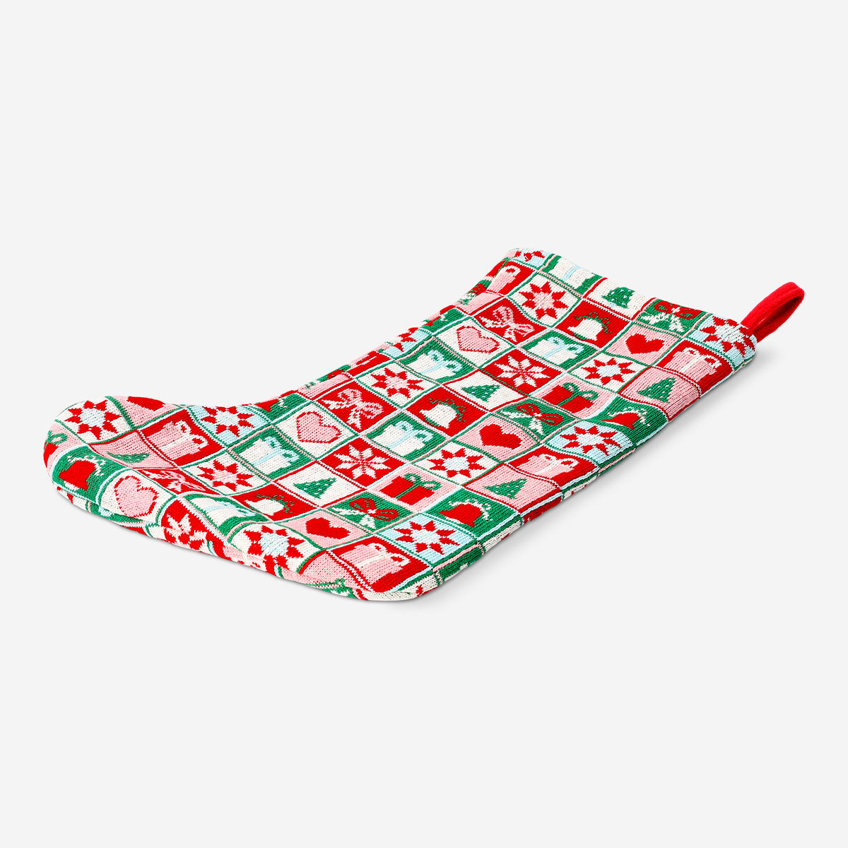 Knitted Christmas stocking by Flying Tiger Copenhagen, cozy home decoration with festive red and white design, hanging on a mantel.