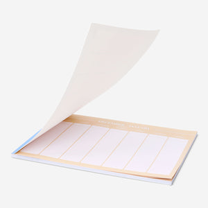Blue A4 weekly planner from Flying Tiger Copenhagen with pages for organizing weekly schedules in an office setting.