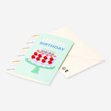 Office birthday card featuring a cake design with colorful pom poms, from Flying Tiger Copenhagen.