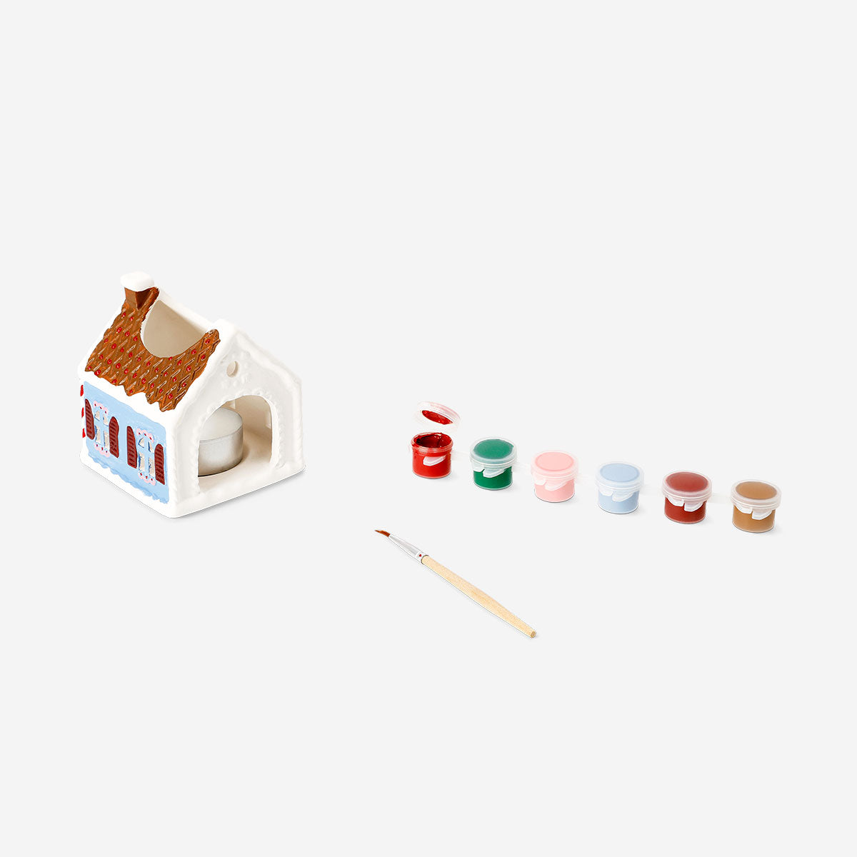 DIY tealight house candle holder from Flying Tiger Copenhagen, featuring a rustic wooden design with cut-out windows for decorative lighting.