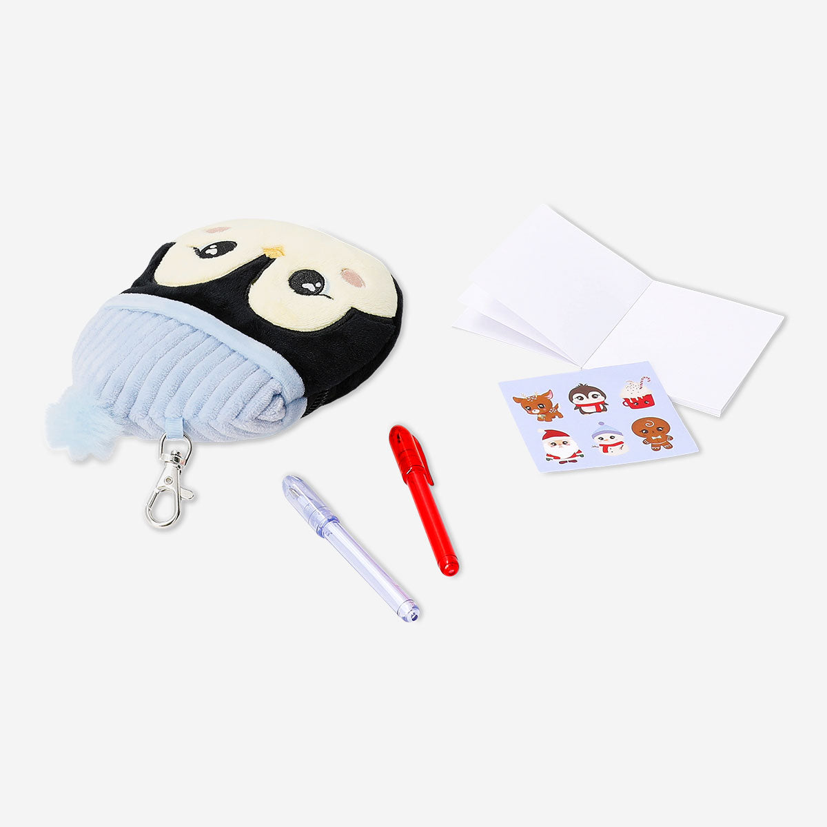 Office stationery kit featuring a plush penguin from Flying Tiger Copenhagen, including pens, notebooks, and stationery accessories.