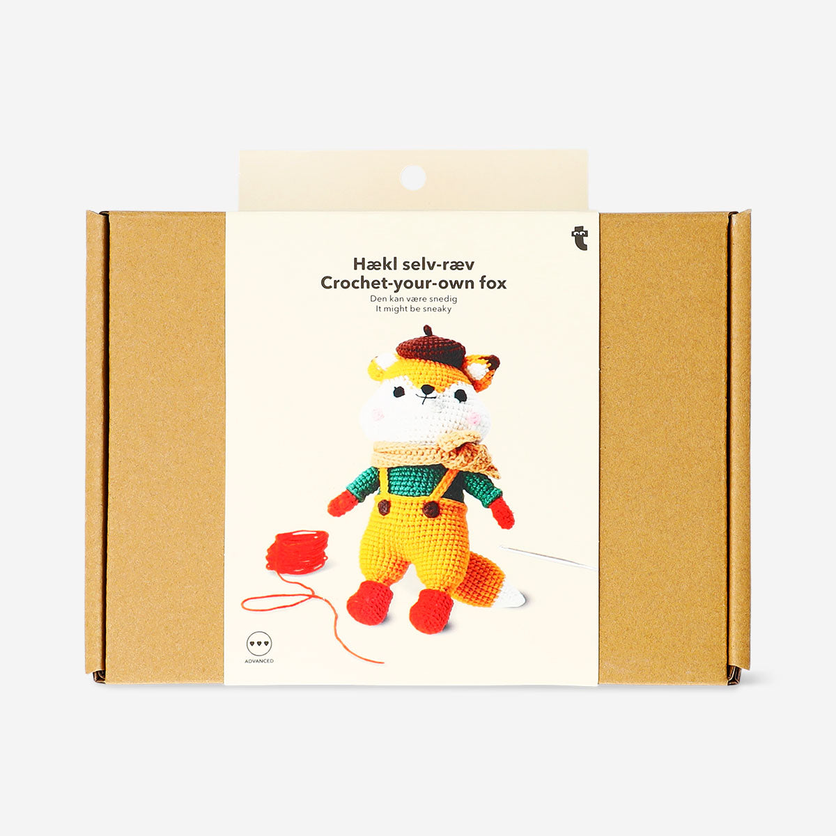Crochet kit from Flying Tiger Copenhagen featuring a fox in a dress, with colorful yarn and crochet tools for crafting.