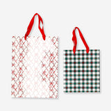 Two office gift bags with bow and heart print designs from Flying Tiger Copenhagen, featuring colorful patterns and sturdy handles.