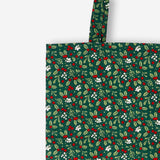 Green textile tote bag with holly leaf and berry patterns, designed by Flying Tiger Copenhagen.
