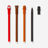 Set of four Flying Tiger Copenhagen erasable office pens with festive Christmas toppers, ideal for holiday note-taking and writing.