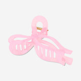 Pink textile bow hairclip with a large decorative bow, stylish accessory from Flying Tiger Copenhagen.