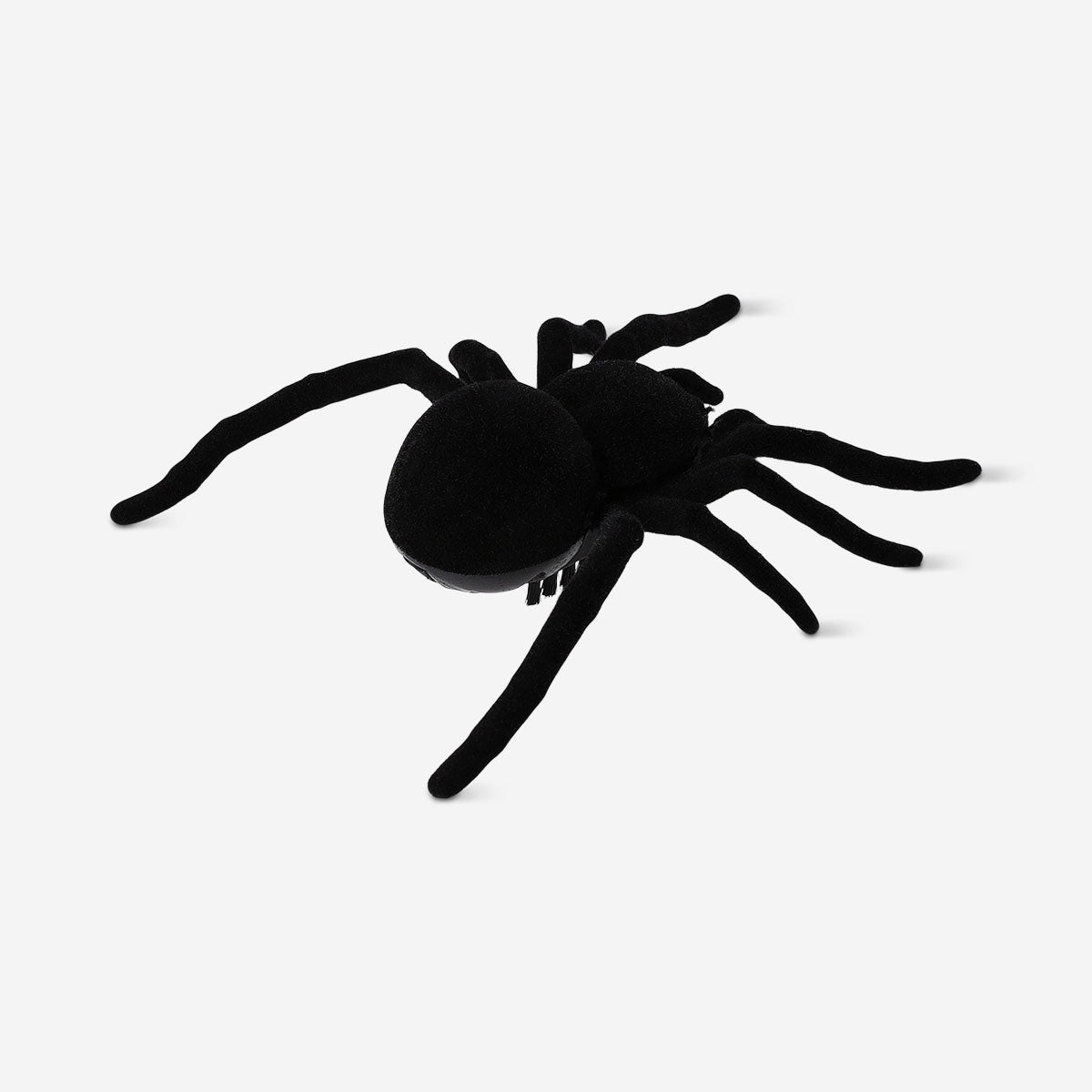 Black vibrating spider toy from Flying Tiger Copenhagen with detailed legs and textured body, designed for sensory play.