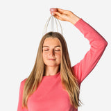 Gold head massager gadget from Flying Tiger Copenhagen with multiple metal prongs for scalp relaxation and head massage.