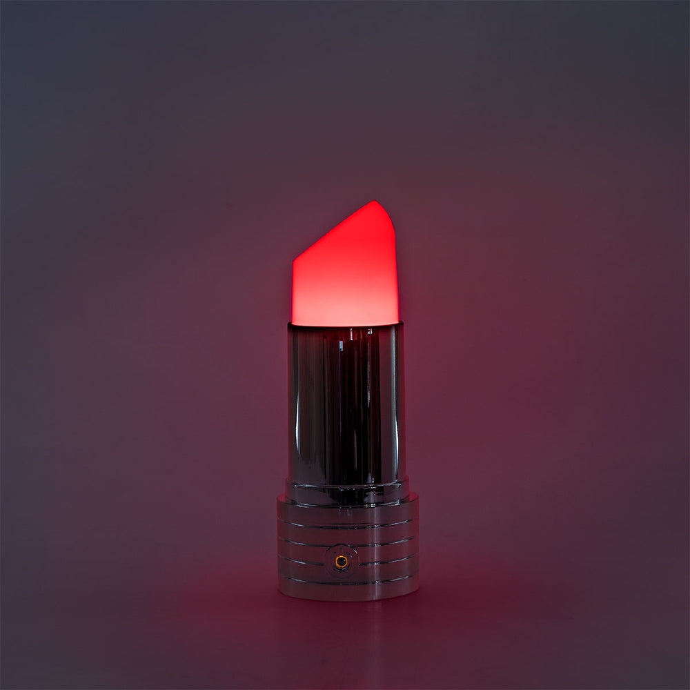 Flying Tiger Copenhagen RuPaul's Drag Race lipstick-shaped cozy home lamp with vibrant pink color and soft lighting.
