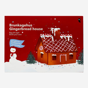 DIY gingerbread house made of baked gingerbread pieces with colorful candy decorations, created as a fun food craft by Flying Tiger Copenhagen.