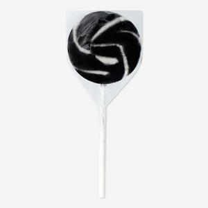 Liquorice-flavored lollipop from Flying Tiger Copenhagen, round candy with black liquorice coating and sweet taste.