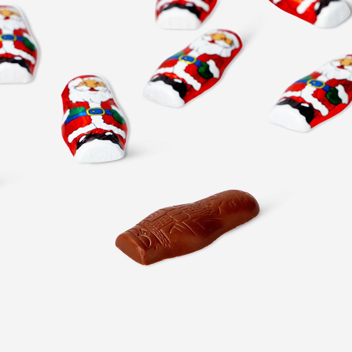 Milk chocolate Santas from Flying Tiger Copenhagen, shaped as festive holiday figures on a plain background.