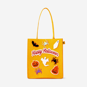Felt trick or treat bag by Flying Tiger Copenhagen filled with vanilla and strawberry-flavored candies for Halloween.