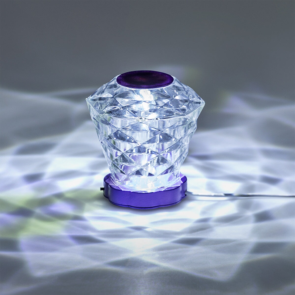 Color-changing diamond-shaped lamp by Flying Tiger Copenhagen, a stylish gadget with vibrant light effects.