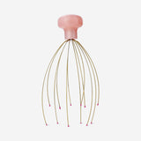 Gold head massager gadget by Flying Tiger Copenhagen, featuring a sleek design with multiple massaging nodes for scalp relaxation.