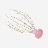 Gold head massager gadget from Flying Tiger Copenhagen with multiple rotating massage nodes for scalp relaxation.