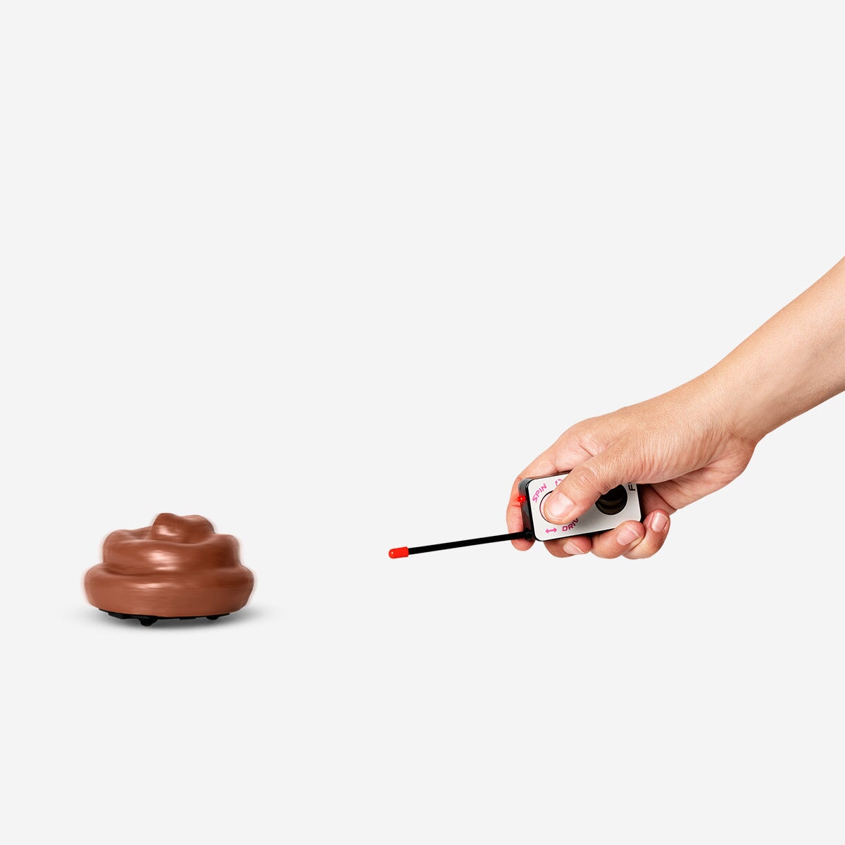 Remote-controlled poo gadget with sound from Flying Tiger Copenhagen, showing a playful, animated figure on a table.