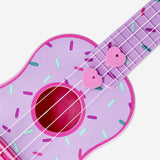 Flying Tiger Copenhagen ukulele featuring a colorful doughnut print, a fun and playful gadget for music lovers.