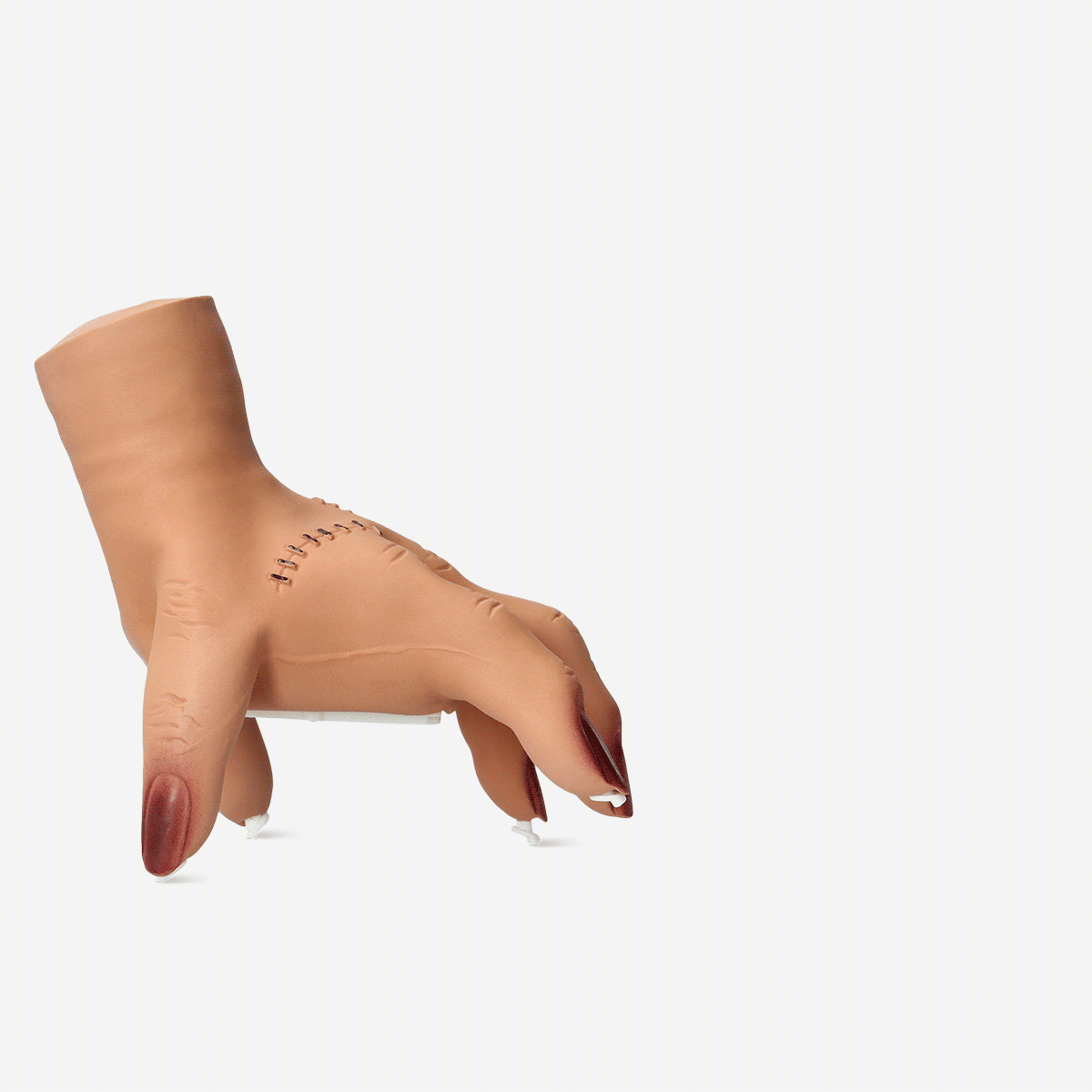 Flying Tiger Copenhagen walking hand gadget with sound, a plastic hand that moves and makes noise when activated.
