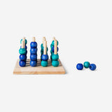 3D four-in-a-row game by Flying Tiger Copenhagen with colorful game pieces on a wooden board.