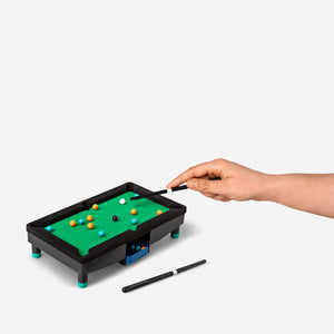 Flying Tiger Copenhagen tabletop pool game with colorful balls and cue sticks on a wooden surface, ideal for fun indoor entertainment.