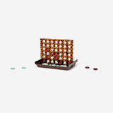 Tortoiseshell Four In A Row game by Flying Tiger Copenhagen, featuring a classic grid and colorful game pieces on a wooden frame.