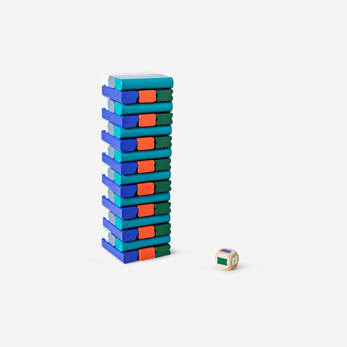 Wooden stacking tower game by Flying Tiger Copenhagen with colorful blocks arranged in a tower on a wooden surface.