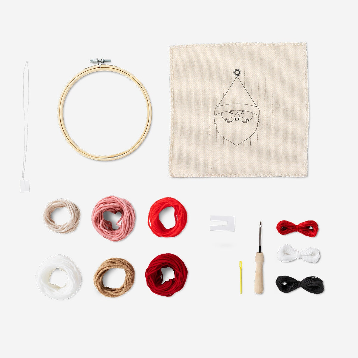 Christmas punch needle embroidery set by Flying Tiger Copenhagen, featuring colorful tools and materials for festive crafting.