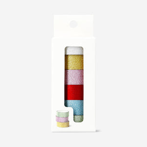 Decorative sparkling tape for hobbies by Flying Tiger Copenhagen, showing colorful, glittery tape roll on a craft surface.