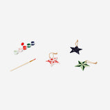 DIY ceramic star ornaments from Flying Tiger Copenhagen, hobby craft with white ceramic stars on a plain background.