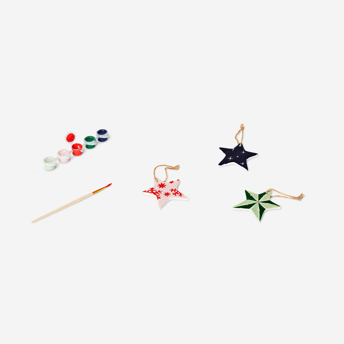 DIY ceramic star ornaments from Flying Tiger Copenhagen, hobby craft with white ceramic stars on a plain background.