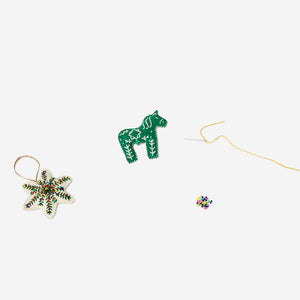DIY sewn ornaments with beads for crafting hobby by Flying Tiger Copenhagen, showcasing colorful fabric and bead details.