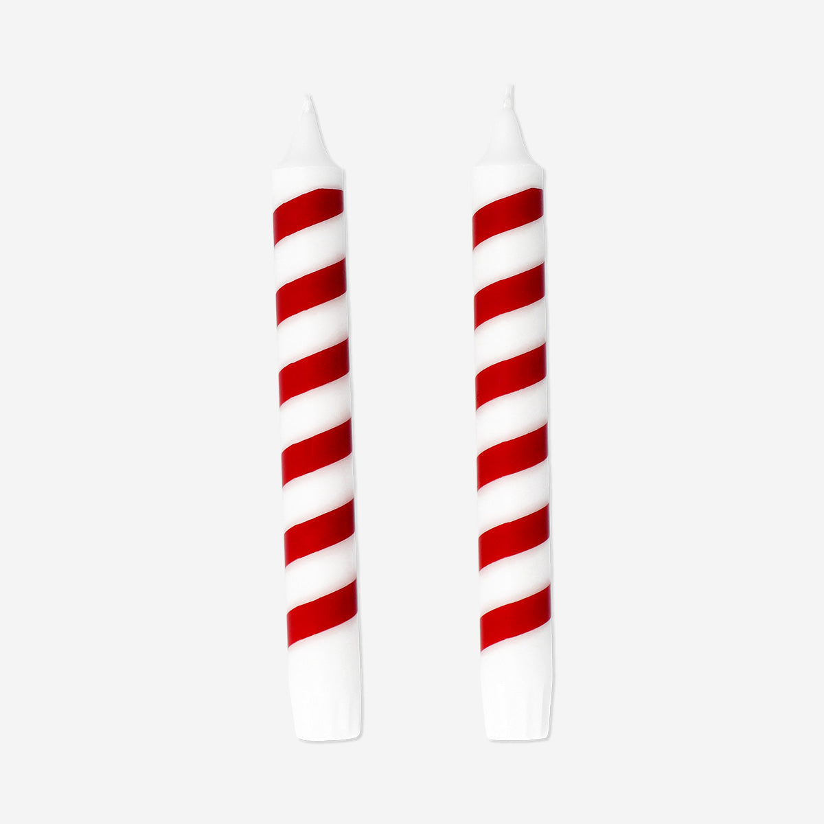 Two candy cane-shaped dinner candles from Flying Tiger Copenhagen, festive red and white holiday decor for table settings.