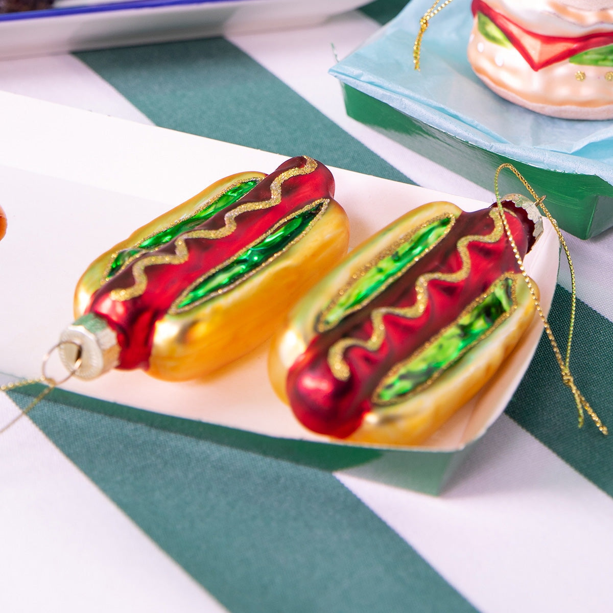 Flying Tiger Copenhagen Christmas bauble shaped like a hotdog, festive holiday decor with colorful, playful design.