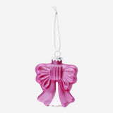 Pink Christmas bauble with a decorative bow from Flying Tiger Copenhagen, hanging on a festive holiday tree.