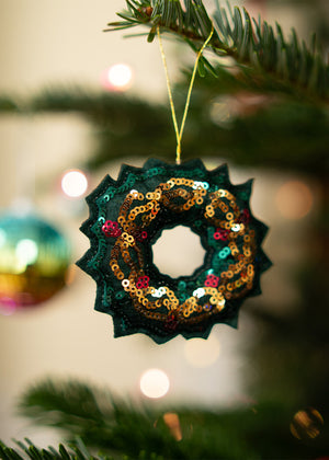Decorative hanging ornament wreath with shiny sequins, designed for home decor by Flying Tiger Copenhagen.