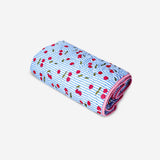 Quilted blanket with cherry print from Flying Tiger Copenhagen, 170x130 cm, cozy home decor throw with floral design.